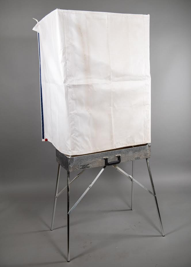 Voting booth, Made by the Douglas Manufacturing Company. Colapsable into a suitcase. Canvas cover with red, white & blue stripes. Table inside, Douglas, 1960+, Aluminum, 30", 13", 73"