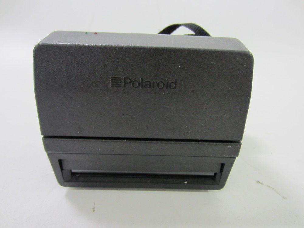 Polaroid 600 One Step Flash, Black Plastic With Nylon Strap, PRACTICAL.  Uses Polaroid i-type film or 600 film.  Introduced: 1992, Black, Polaroid, 1990s+, Plastic, 5.75", 5.25", 3.75"