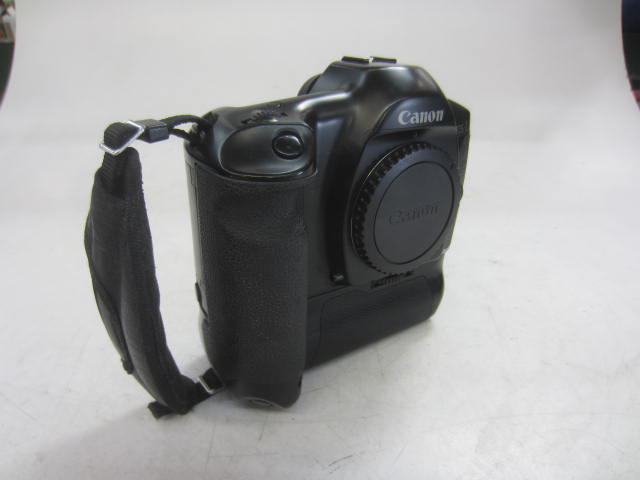 Camera, 35mm, Canon Model EOS-1 Camera Body, Serial Number 119552, With Cap And BP Attached With Wrist Strap, Non-Operational, Black, Canon, 1990s+, Metal