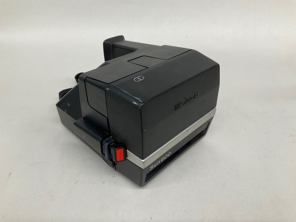 Polaroid Model Sun 600, Has Strap. Uses Polaroid 600 series film. Readily available as of 04/23/2019.  Introduced: 1981, Black, Polaroid, 1980s+