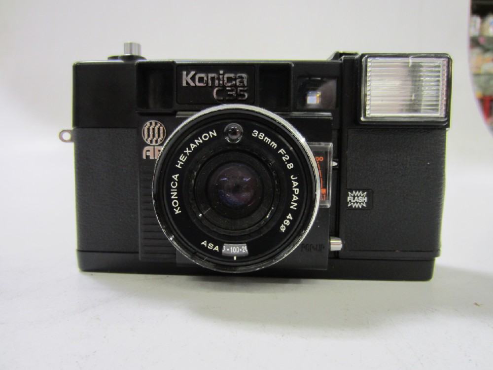 Konica C35 AF, With neck strap and electonic flash. Introduced in 1977. Ues two AA Batteries. , Black, Konica, 1970+, Plastic
