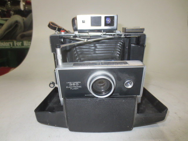 Polaroid Land Camera Model 360 Electronic Flash.  With Thin Leather Neck Strap Attached.  Non Operational. Used Polaroid 100-series Packfilm (no longer available).  Introduced 1969., Black, Polaroid, 1970s+, Metal