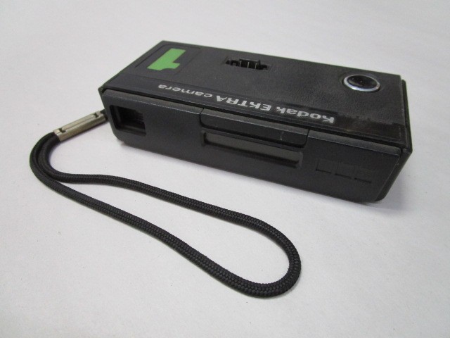 Kodak Ektra 1 with wrist strap. Amature camera, Manufactured 1978 thru 1984. Uses 110 film.  Does not need batteries to operate expendable Flip Flash (sold seperately)., Black, Kodak, 1970+, Plastic