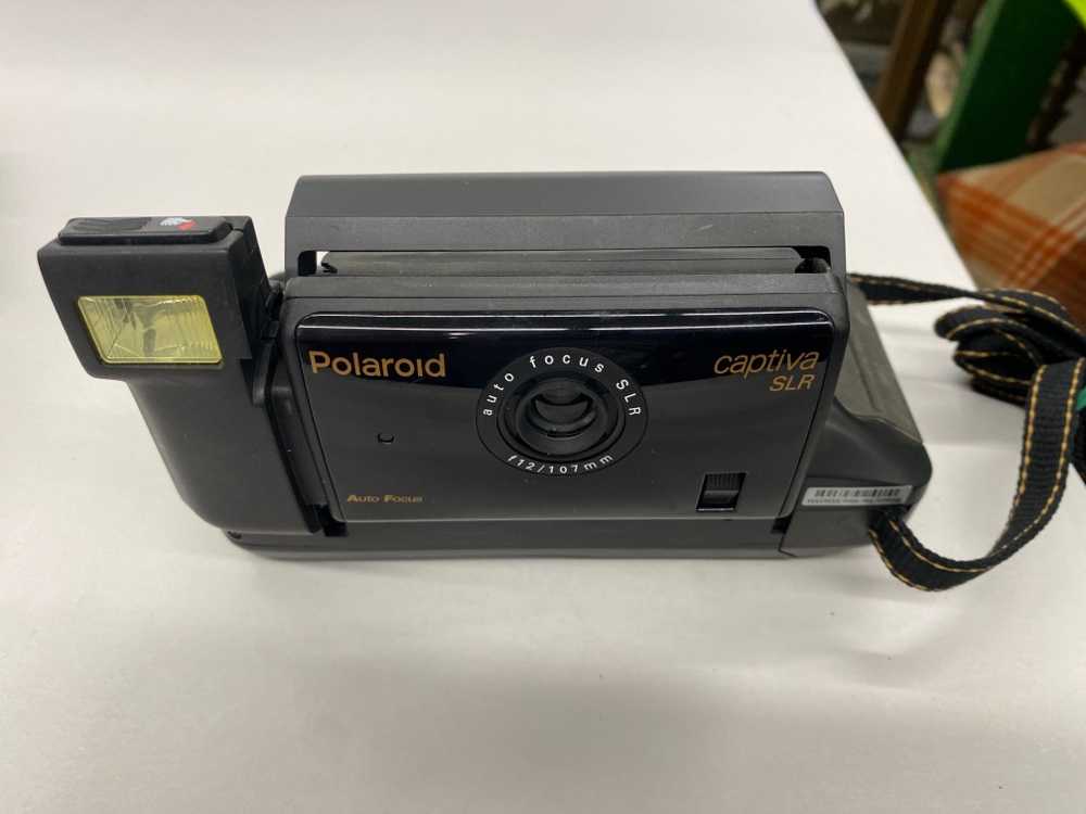 Polaroid Captiva SLR.  Uses Polaroid 500 & 35 Film types (Not 35mm).  Introduced 1993., Silver, Polaroid, 1990s+, Metal