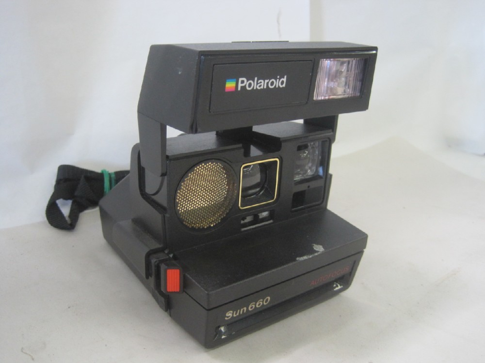 Polaroid Model Sun 660, With Neck Strap, Uses Polaroid 600 Series Film, Which Is Readily Available As Of 04/23/2019.  Introduced: 1981, Black, Polaroid, 1980s+, Plastic