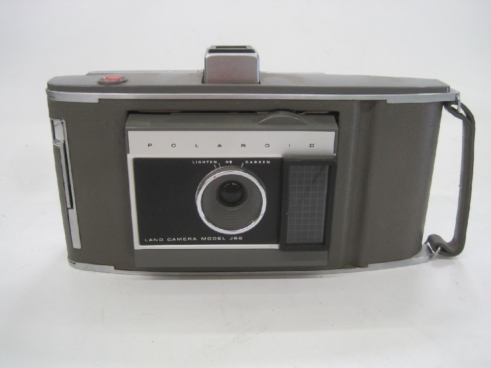 Polaroid Land Camera Model J66, Lense Expands Out, Has Small Carrying Handle. Used Type-40 Instant Roll Film which is no longer available.  Introduced: 1961, Gray, Polaroid, 1960s+, Plastic, 10"w, 5"h, 2.5"d