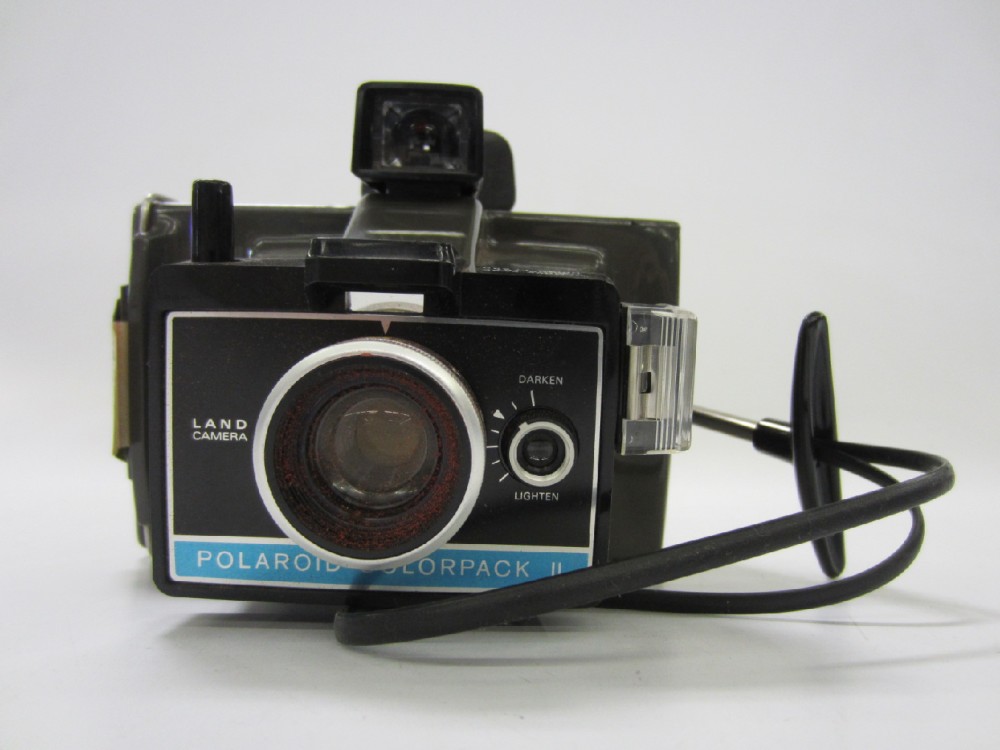 Polaroid Colorpack II, Black Wrist Strap, Uses Flash Cubes. Type 669 Polaroid film Or Fujifilm's FP-100C and FP-100B.  Introduced 1969, Brown, Polaroid , 1970s+, Plastic, 7"w, 6"h, 5"d