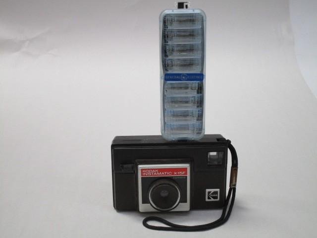 Camera, Kodak Instamatic X-15F, Amateur Camera With Wrist Strap, Manufactured From 1976 To 1981, Uses 126 Film, Does Not Need Batteries To Flash, Uses Expendable Flip Flash (Sold Seperately), Brown, Kodak, 1970s+, Plastic