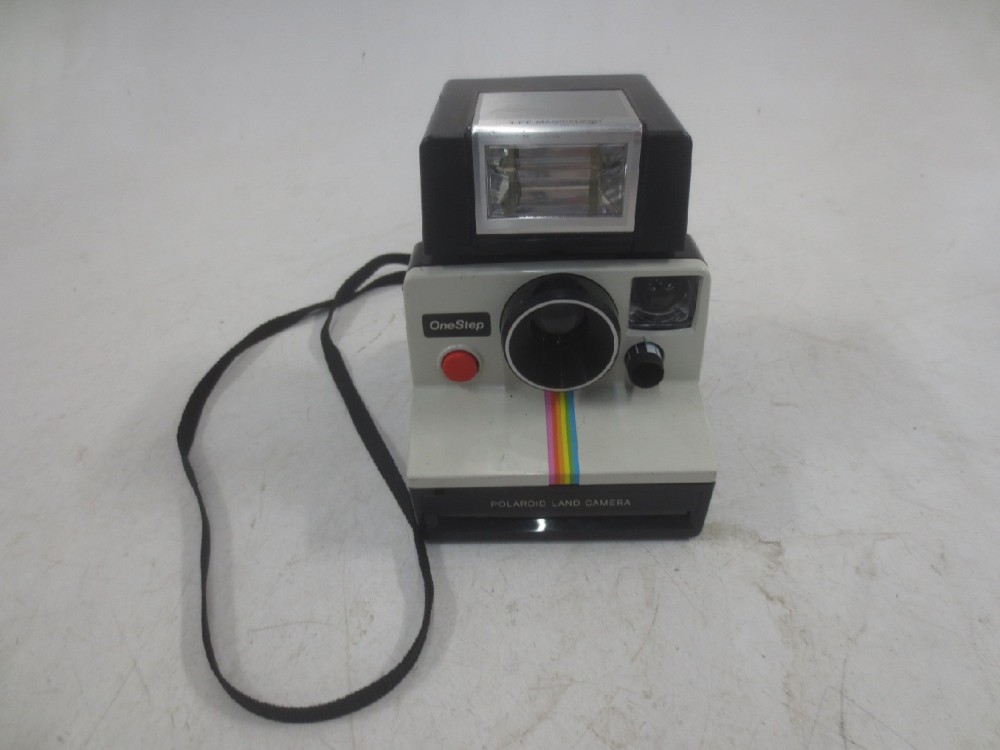 Polaroid OneStep with flash unit. Uses Polaroid SX 70 film, readily available as of 04/23/2019.  Introduced: 1978, Black, Polaroid, 1970s+, Plastic